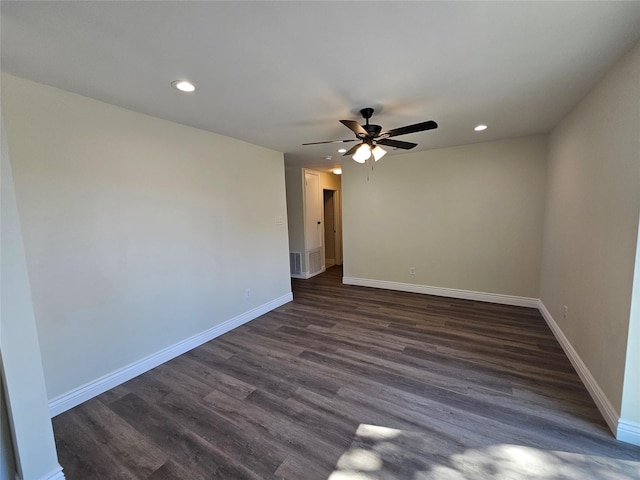 spare room featuring ceiling fan and dark hardwood / wood-style floors