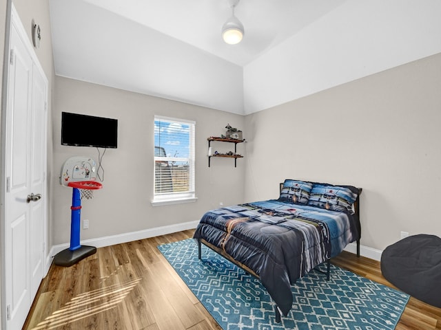 bedroom with lofted ceiling and hardwood / wood-style flooring