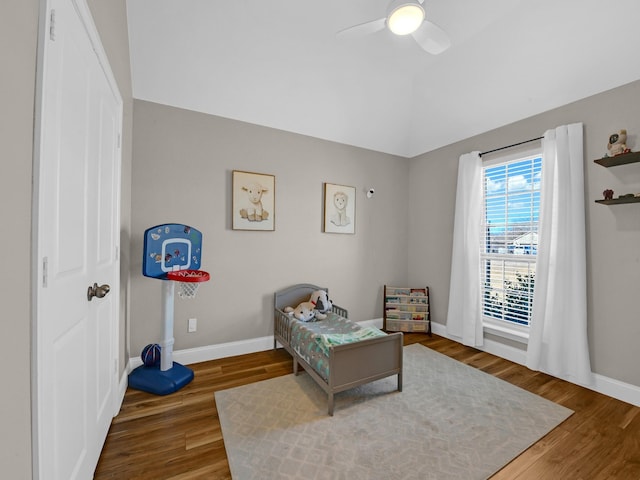 living area with ceiling fan, lofted ceiling, and wood-type flooring