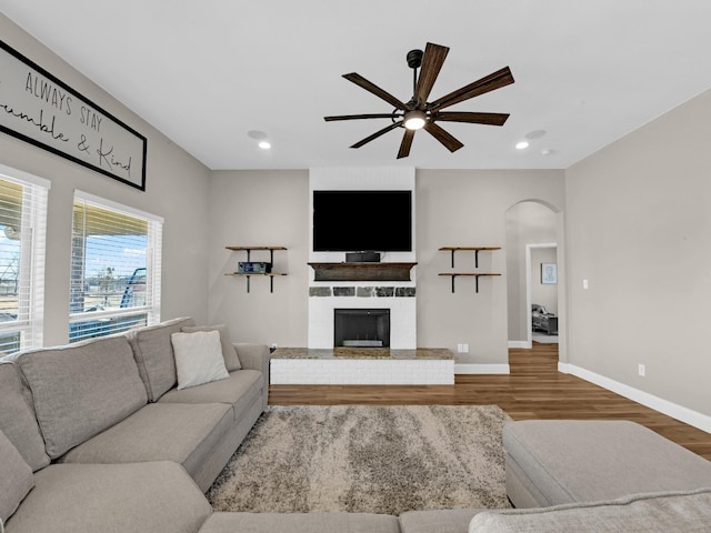 living room featuring wood-type flooring and ceiling fan