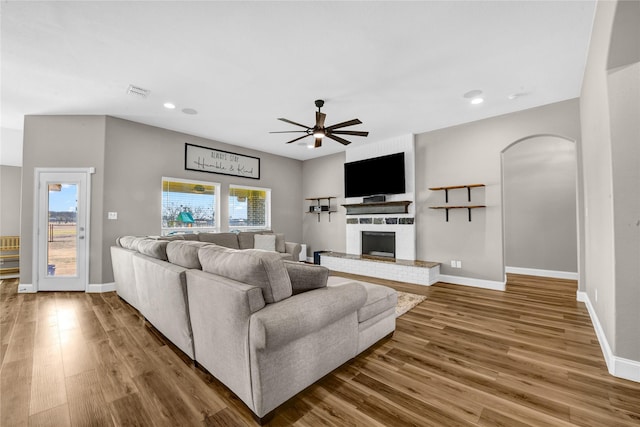 living room with hardwood / wood-style flooring and ceiling fan