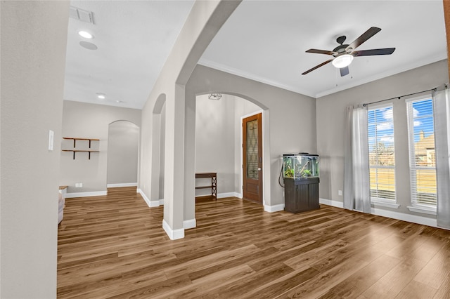 unfurnished room with hardwood / wood-style flooring, ornamental molding, and ceiling fan