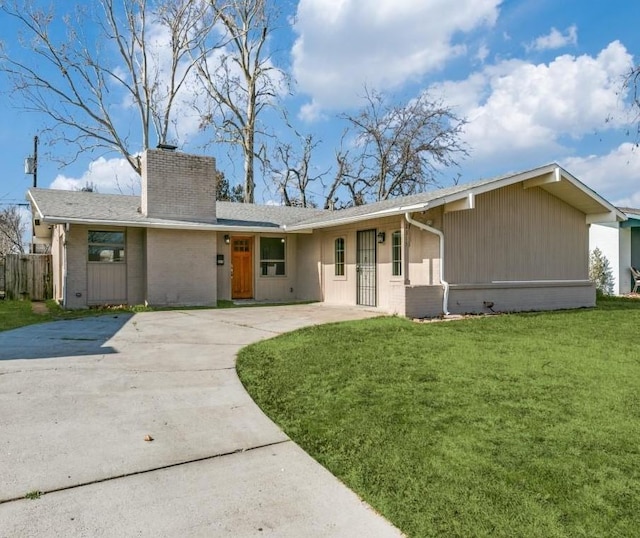 rear view of property with a lawn