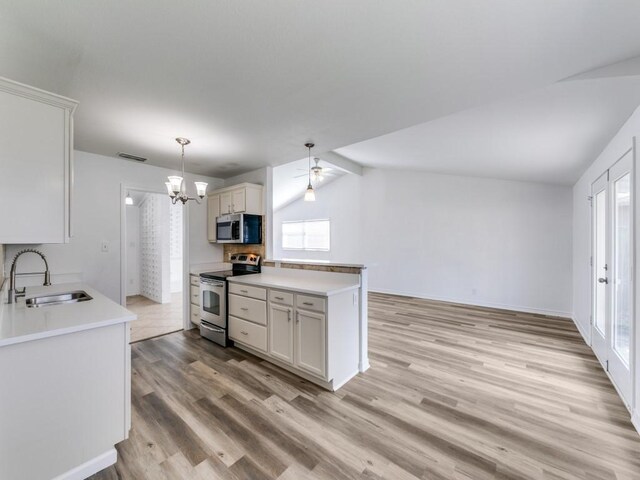 kitchen featuring white cabinetry, appliances with stainless steel finishes, sink, and light wood-type flooring