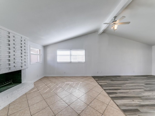 unfurnished living room featuring light tile patterned flooring, ceiling fan, a brick fireplace, and vaulted ceiling with beams