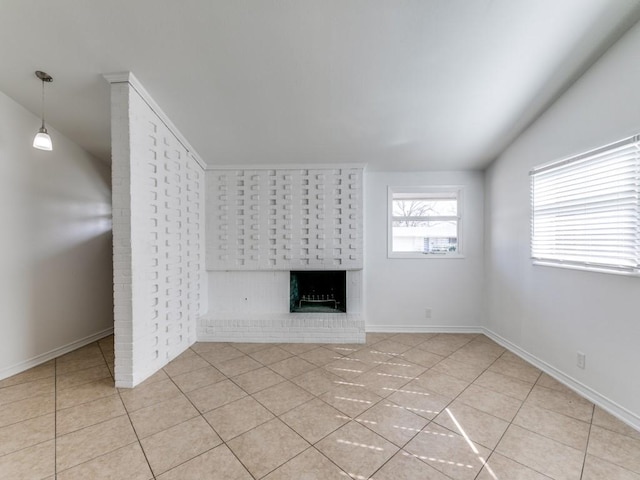 unfurnished living room featuring lofted ceiling, a fireplace, and light tile patterned floors