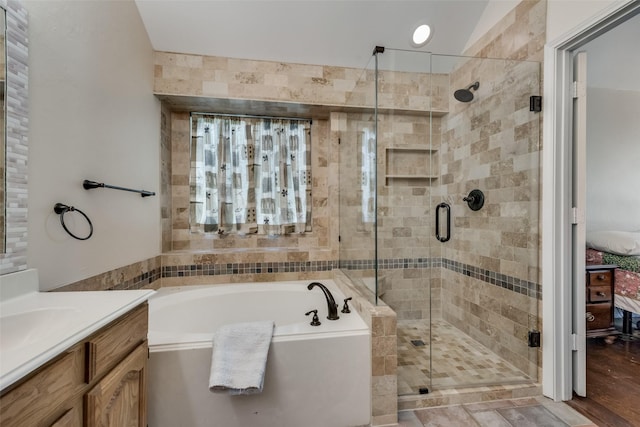 bathroom featuring vanity and separate shower and tub