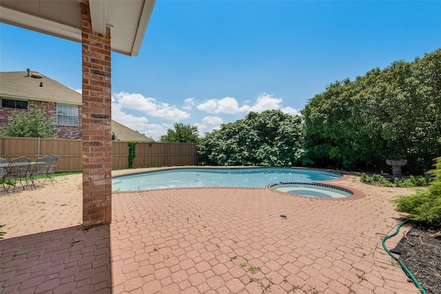 view of swimming pool with an in ground hot tub and a patio area