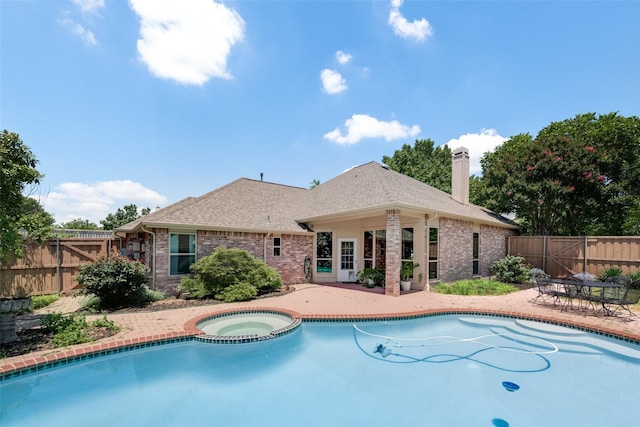 view of pool featuring an in ground hot tub and a patio area