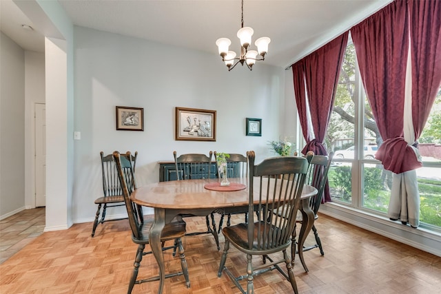 dining area with light parquet flooring and a chandelier