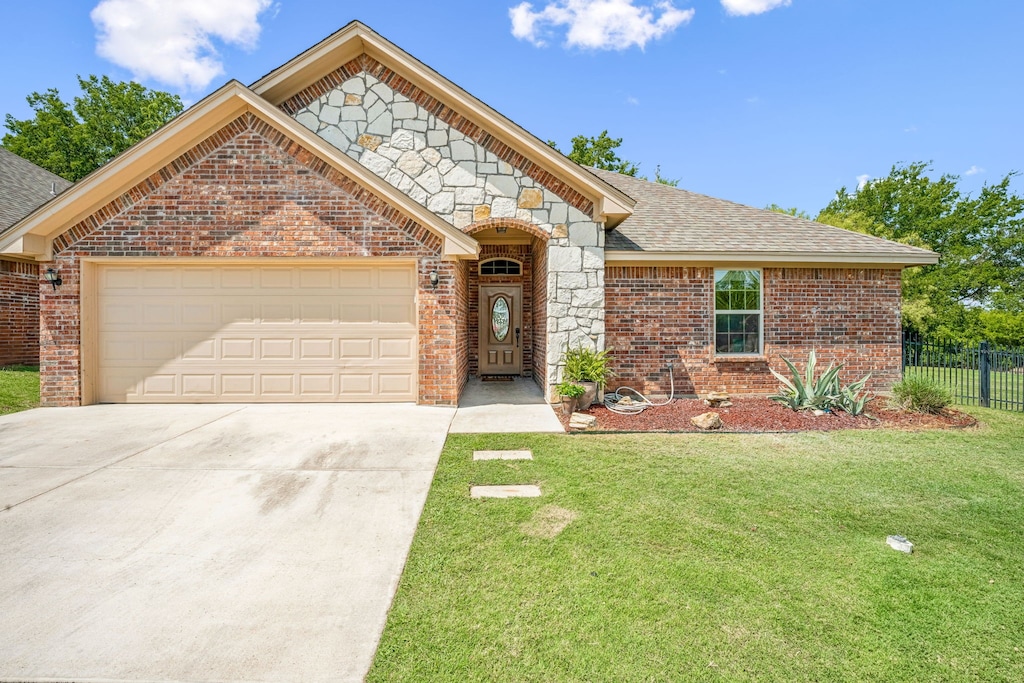 view of front facade with a garage and a front lawn