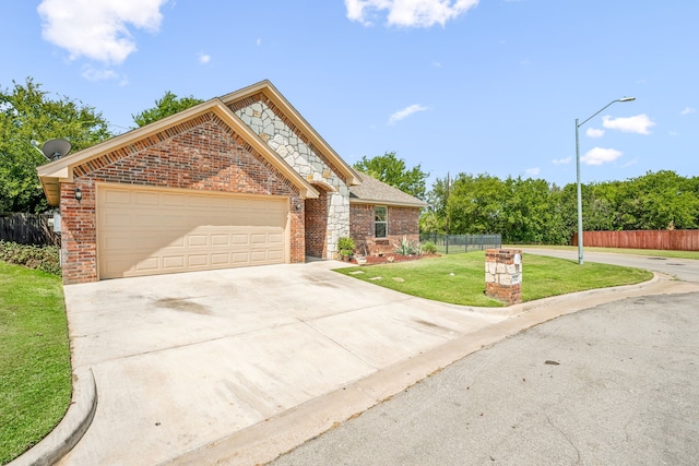 view of front of property with a garage and a front yard