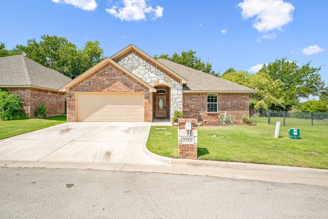 view of front of house with a garage and a front lawn