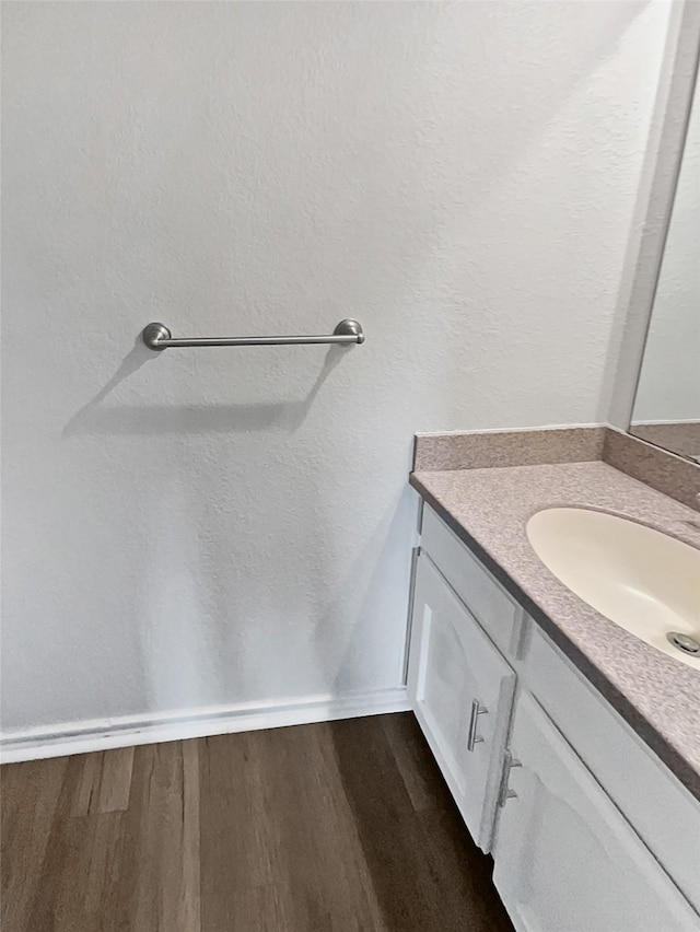 bathroom with vanity and hardwood / wood-style floors