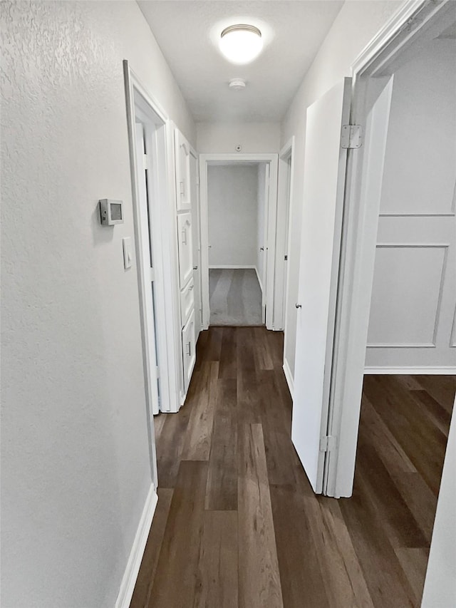 hall with dark hardwood / wood-style floors