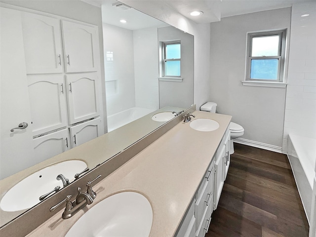 bathroom with vanity, wood-type flooring, toilet, and plenty of natural light