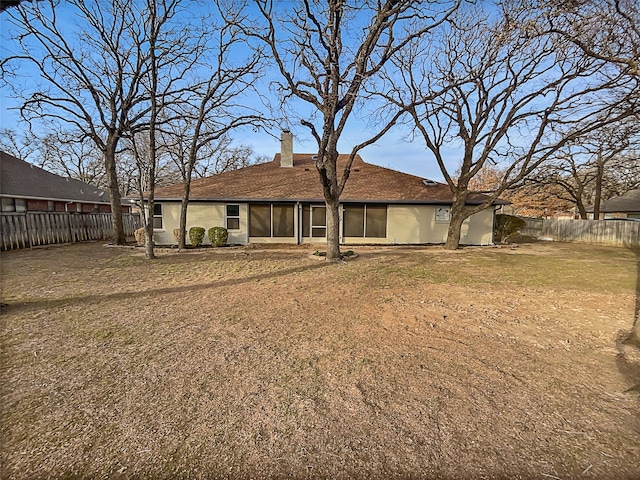 back of house with a lawn