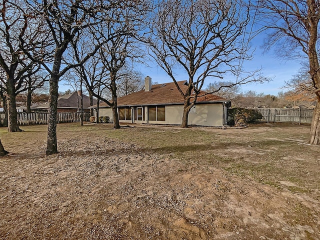 back of house featuring a lawn