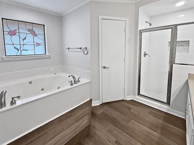 bathroom featuring independent shower and bath, vanity, and hardwood / wood-style flooring