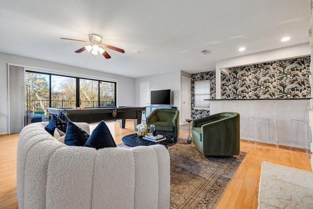 living room with ceiling fan, pool table, and hardwood / wood-style floors