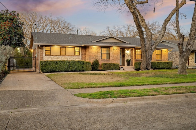 ranch-style home featuring a lawn