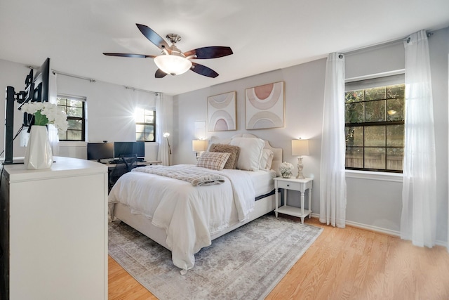 bedroom with ceiling fan and light hardwood / wood-style floors