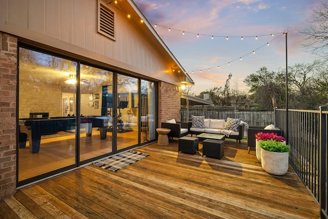 deck at dusk featuring an outdoor hangout area