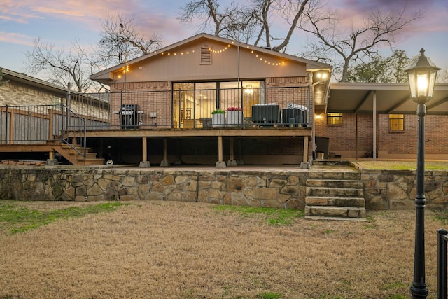 back house at dusk with a wooden deck