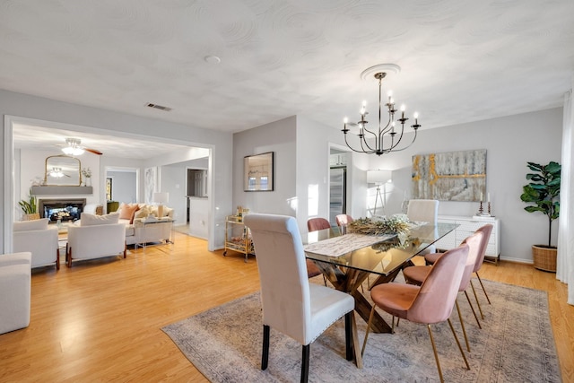 dining area featuring an inviting chandelier and light wood-type flooring