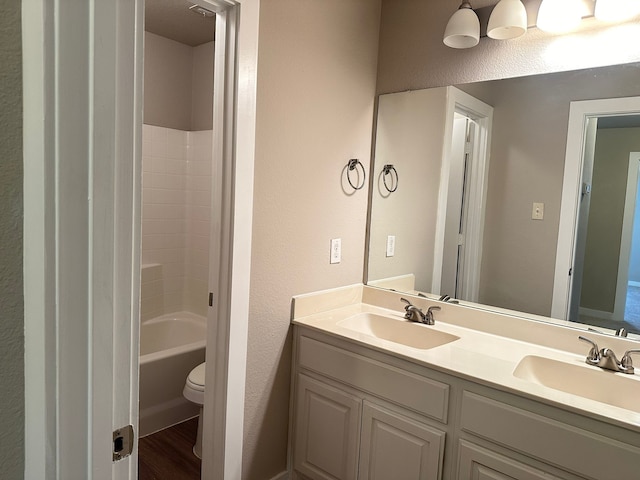 bathroom featuring vanity, hardwood / wood-style floors, and toilet