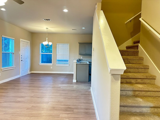 interior space with hardwood / wood-style flooring, sink, and a chandelier