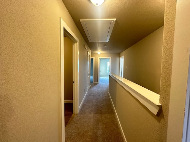 hallway featuring dark carpet