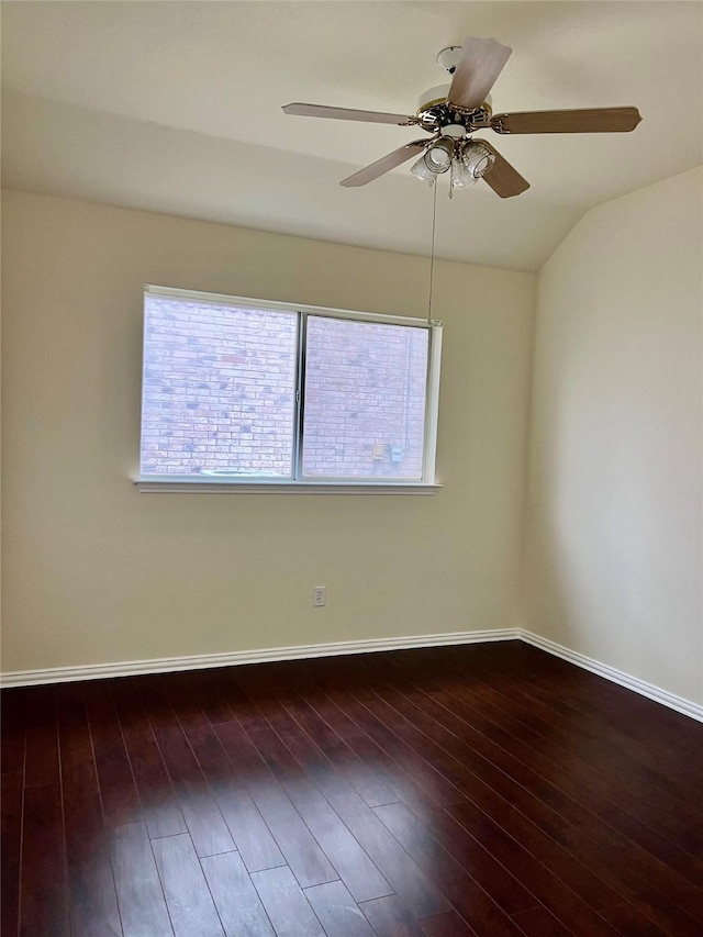 empty room with a healthy amount of sunlight, baseboards, wood finished floors, and lofted ceiling