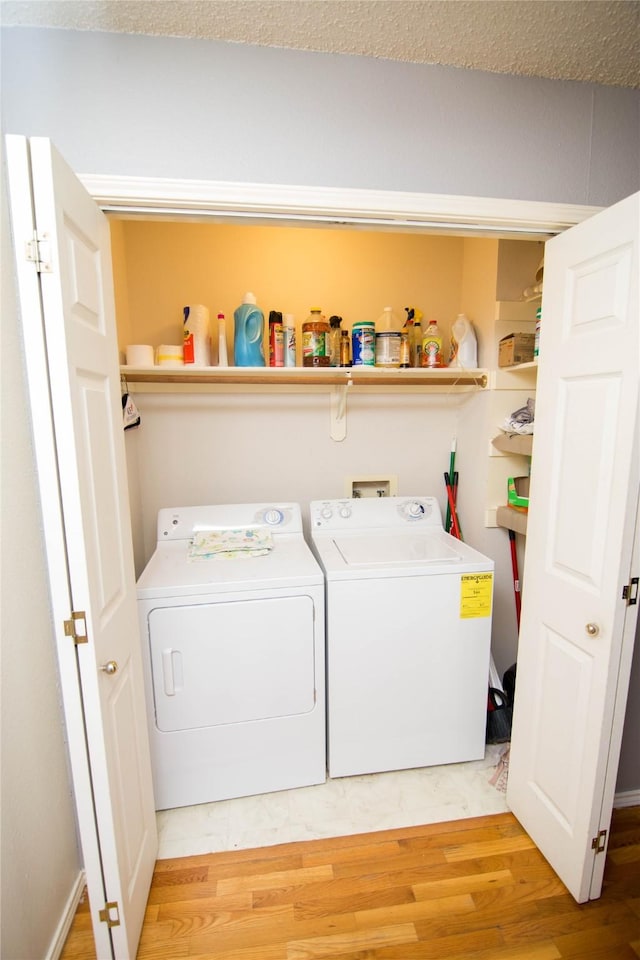 laundry area featuring light hardwood / wood-style floors and independent washer and dryer