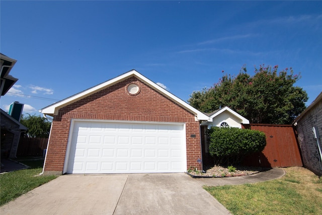 view of front of house featuring a garage and an outbuilding