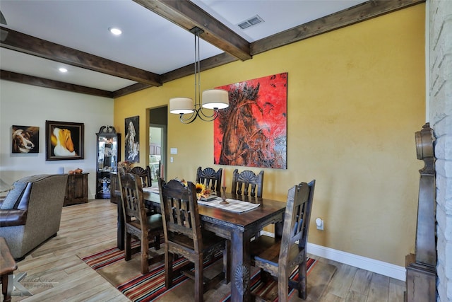 dining space featuring an inviting chandelier, light hardwood / wood-style floors, and beamed ceiling