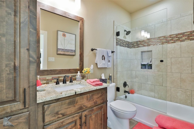 full bathroom featuring enclosed tub / shower combo, vanity, and toilet