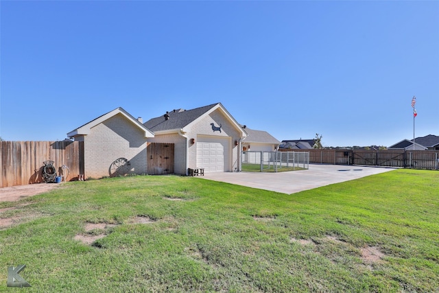 single story home featuring a garage, a patio area, and a front yard