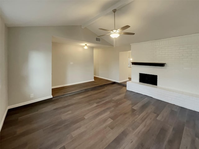 unfurnished living room with a brick fireplace, dark wood-type flooring, vaulted ceiling with beams, and ceiling fan