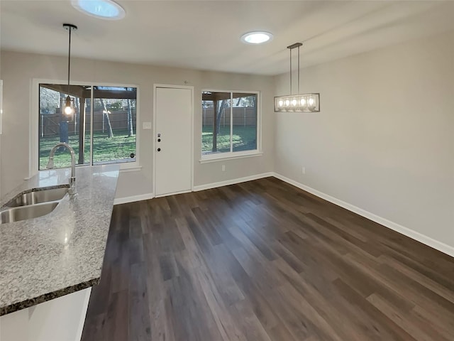 unfurnished dining area featuring sink and dark hardwood / wood-style flooring