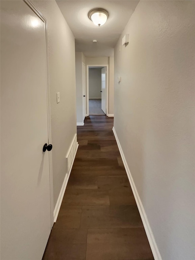 corridor with dark hardwood / wood-style floors