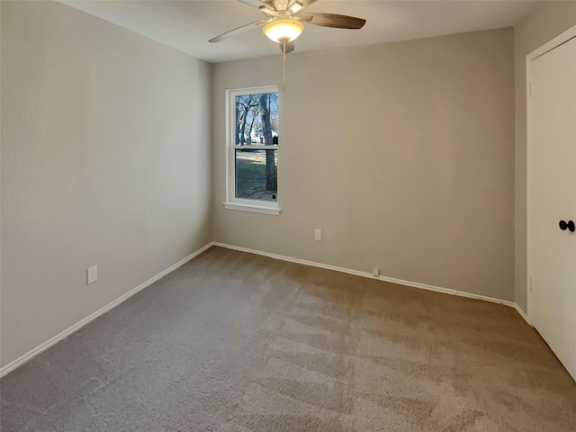 spare room featuring ceiling fan and light colored carpet