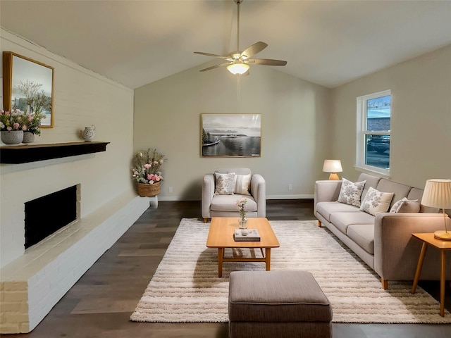 living room featuring a brick fireplace, dark hardwood / wood-style floors, lofted ceiling, and ceiling fan