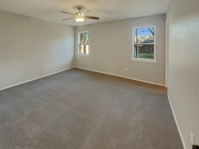 carpeted spare room with ceiling fan