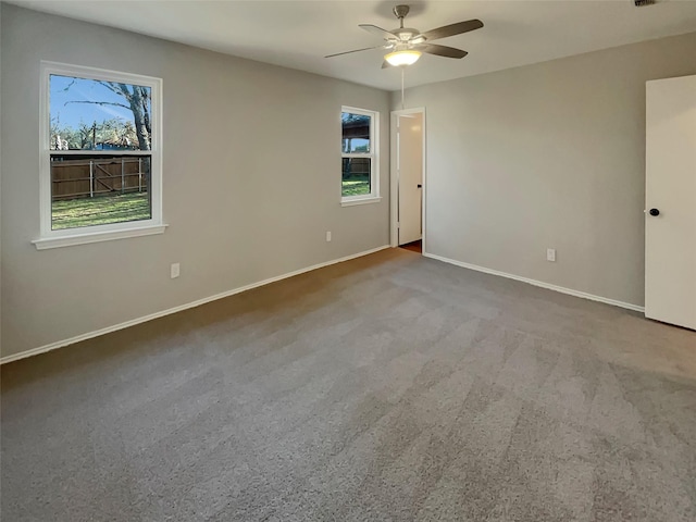 spare room with carpet flooring and ceiling fan