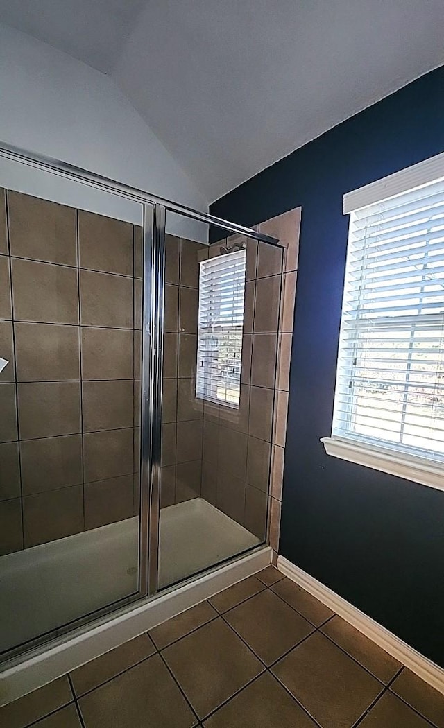 bathroom featuring tile patterned flooring, lofted ceiling, and an enclosed shower