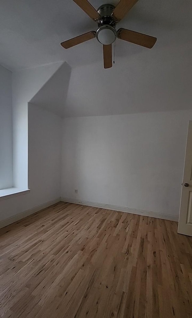 additional living space featuring lofted ceiling and light hardwood / wood-style flooring