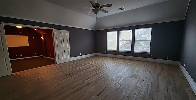 unfurnished room featuring vaulted ceiling, hardwood / wood-style floors, and ceiling fan