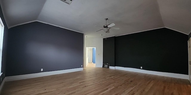 unfurnished room with ceiling fan, lofted ceiling, and light wood-type flooring