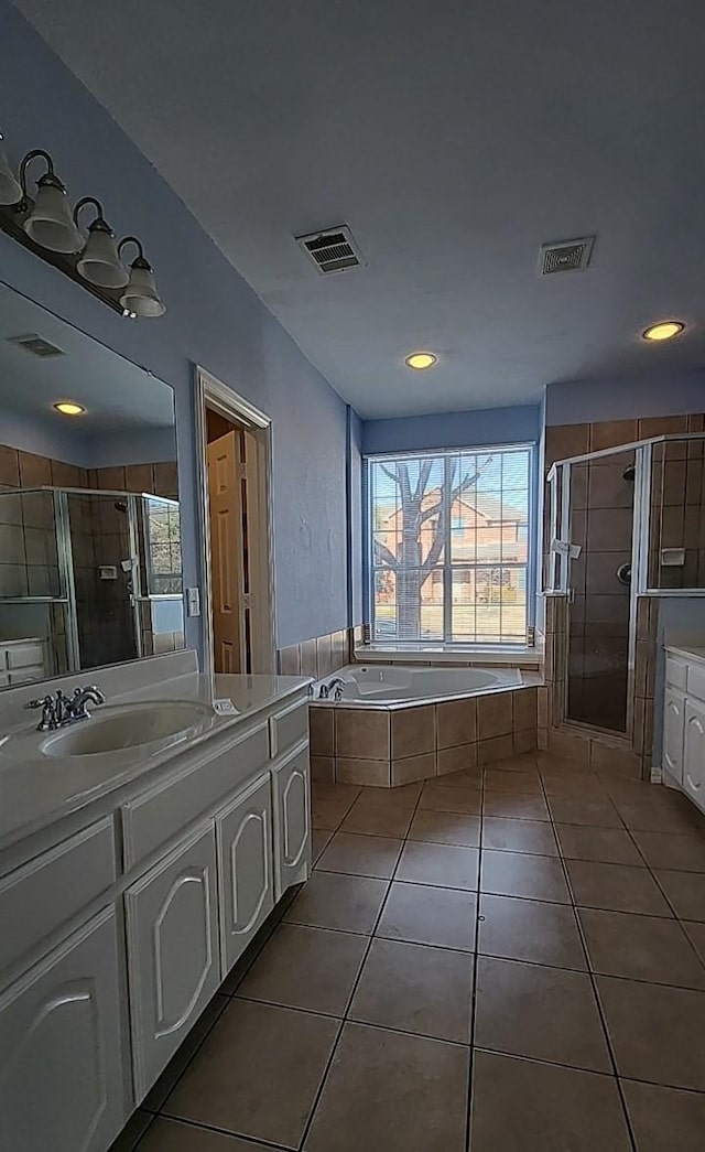 bathroom with independent shower and bath, vanity, and tile patterned floors